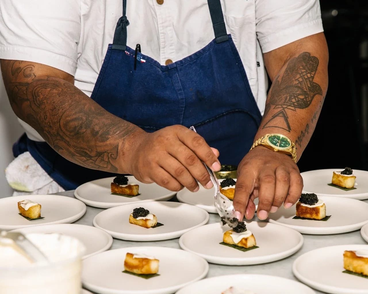 A chef plating bites for a client event